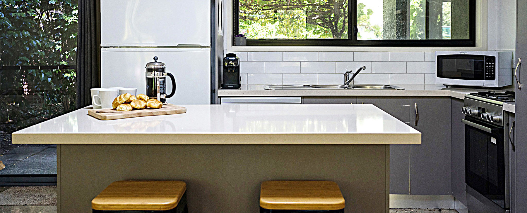 10a-New-kitchen-with-gas-cooking,-Nespresso-coffee-machine,-full-fridge-and-outlook-to-BBQ-and-back-garden